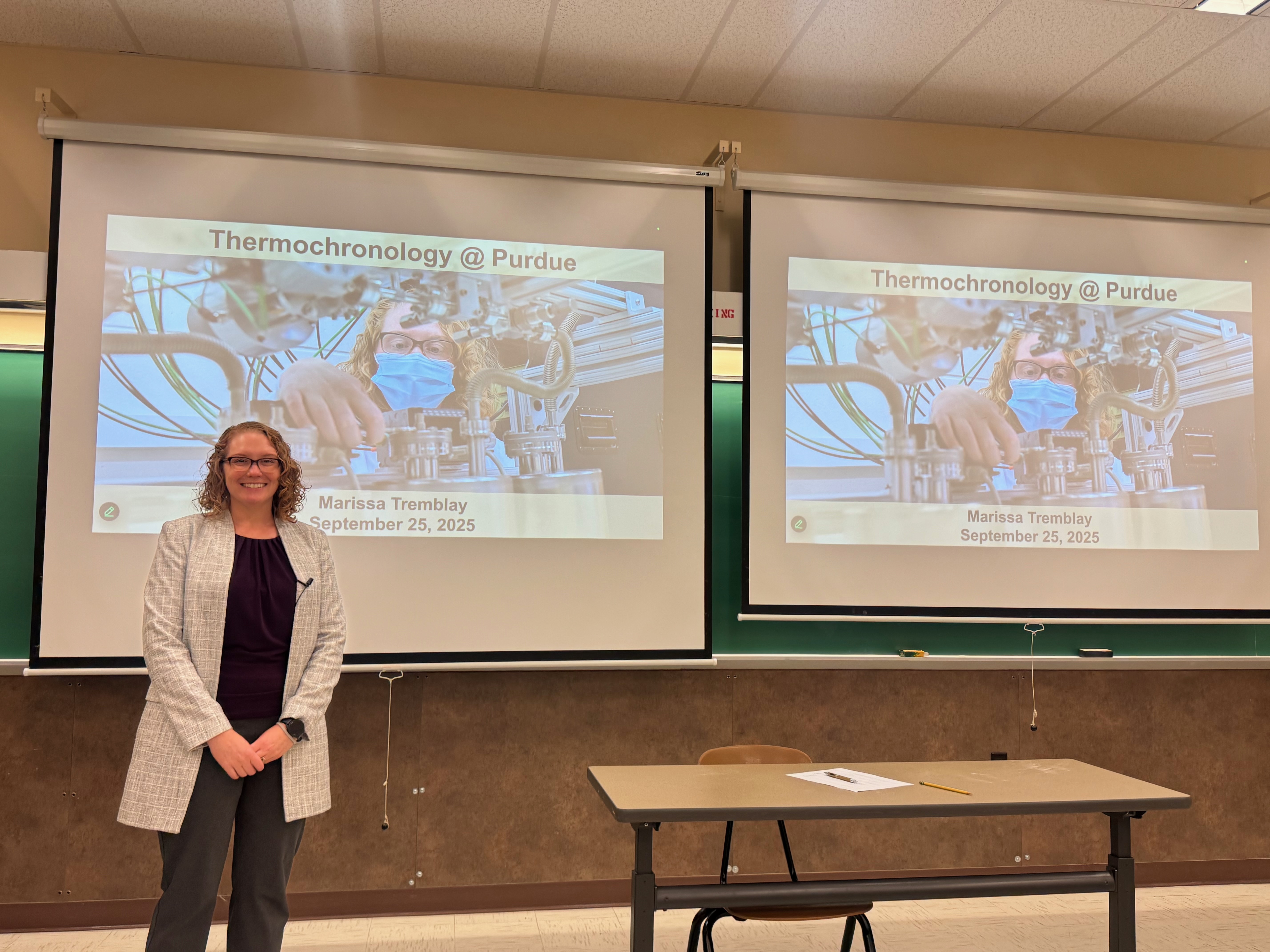 Marissa standing with her talk title slide.